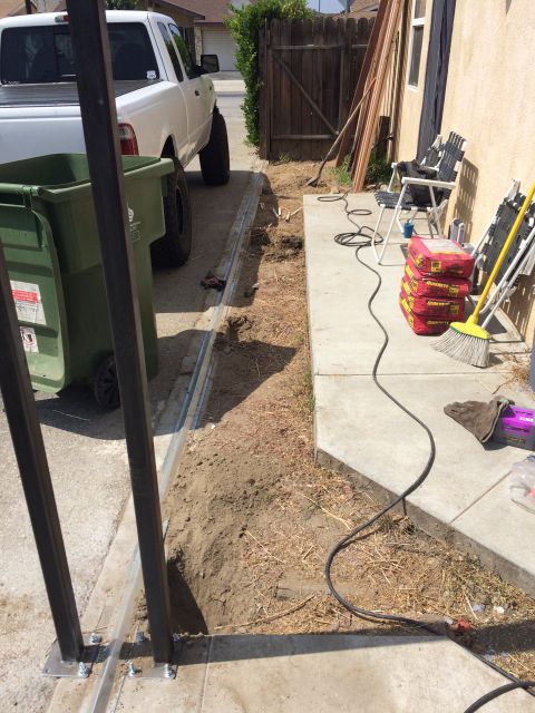 1968 Ford Mustang - A white pickup truck is parked in a driveway next to a trash bin and construction materials.
