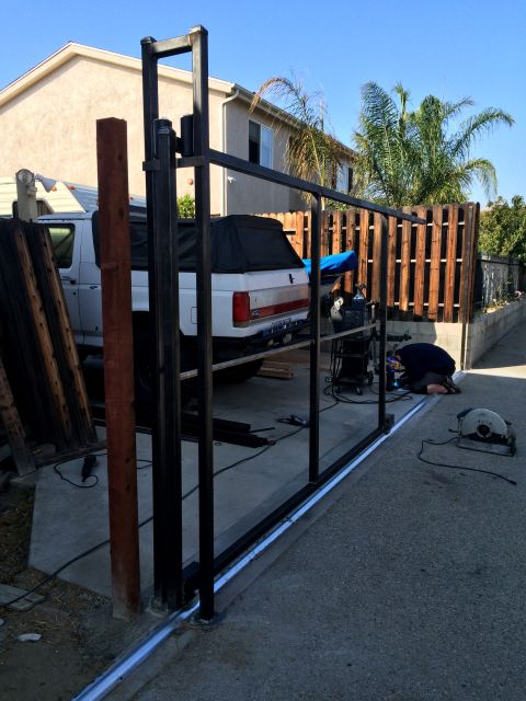 1968 Ford Mustang - A white pickup truck is parked in a driveway next to a fence being constructed.