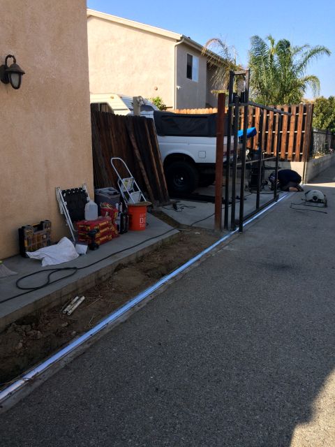 1968 Ford Mustang - A white pickup truck is parked in a driveway next to a fence under construction.