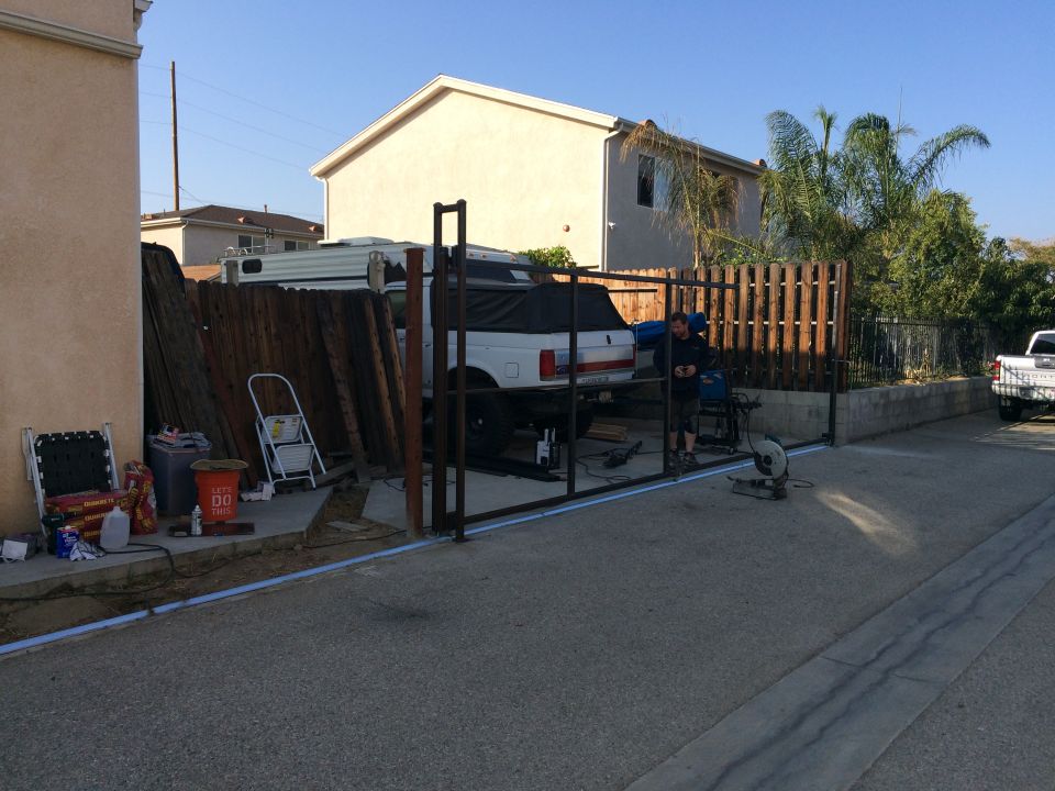White pickup truck covered with a tarp, undergoing construction