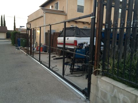 1968 Ford Mustang - A white pickup truck is parked behind a metal gate under construction.