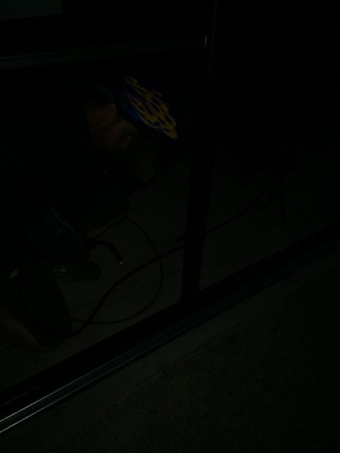 1968 Ford Mustang - A person is welding in a dark environment, with equipment and cables visible on the ground.