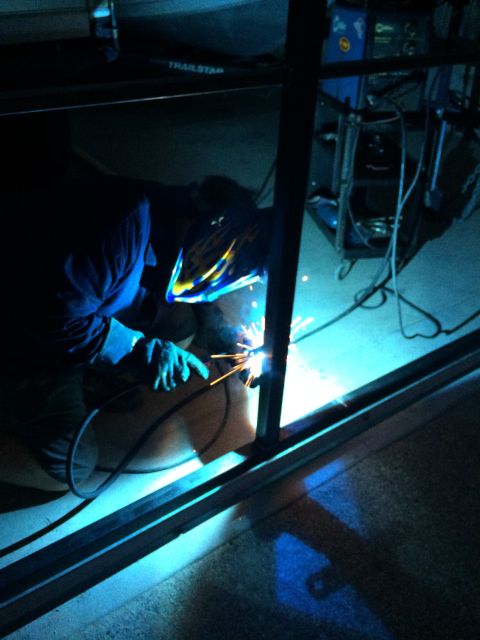 1968 Ford Mustang - Welder at work, creating sparks while joining metal components.