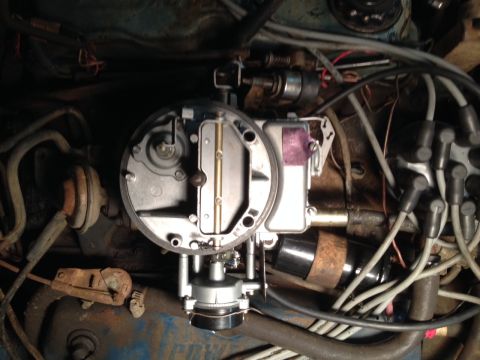 1973 Ford Bronco - Close-up view of engine components, including a carburetor and distributor cap.