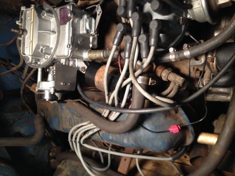 1973 Ford Bronco - Close-up view of an engine bay, focusing on the carburetor and spark plug wires.