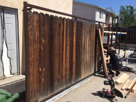 1968 Ford Mustang - A white pickup truck is partially visible behind a wooden fence being worked on by a person.
