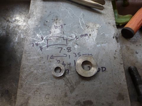 1964 Mercury Monterey - Handwritten notes and measurements accompany two washers on a workbench surface.