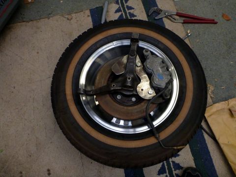 1964 Mercury Monterey - A tire and disc brake assembly are shown, with tools in the background.