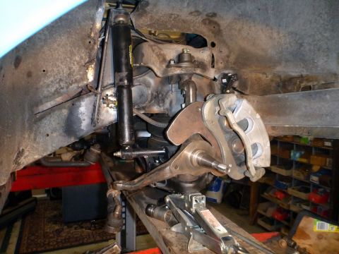 1964 Mercury Monterey - Close-up view of the front suspension system of a vehicle, showing various mechanical components.