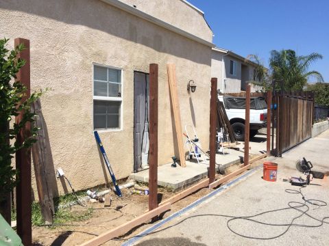 1968 Ford Mustang - A white pickup truck is visible behind construction materials and a wooden fence.