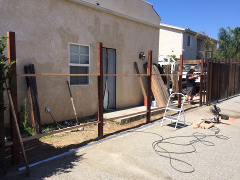 1968 Ford Mustang - Fence construction in progress with materials and tools laid out.
