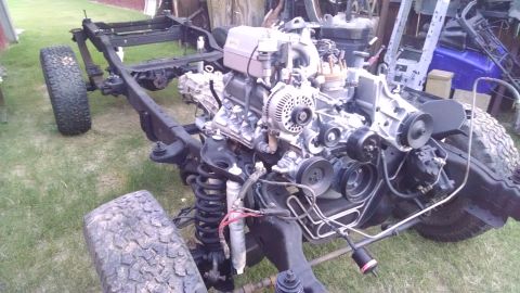 1993 Ford Bronco - The plenum, alternator, block ground stud & battery/starter harness, PS lines, & MagneFine filters then went on.