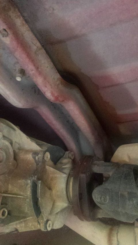 1995 Ford Bronco - Close-up view of the undercarriage, showing the driveshaft and exhaust system components.