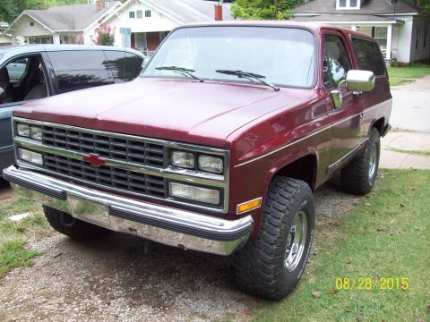 1989 Chevrolet Blazer - This maroon SUV is parked in a residential area with a date stamp indicating it was photographed in 2015.