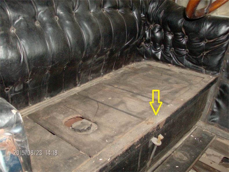 Interior view of a 1914 Ford Model T showing the floor pan and tufted leather seats