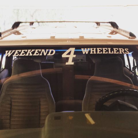 1994 Jeep Grand Cherokee - The rear window of a vehicle displays a "WEEKEND 4 WHEELERS" decal, hinting at its off-road capabilities.