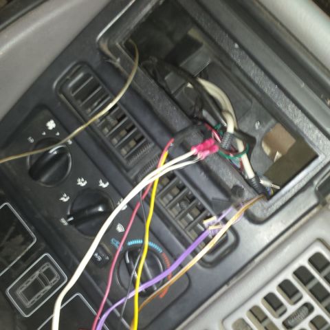1994 Jeep Grand Cherokee - Vehicle interior showing exposed wiring and climate control knobs.