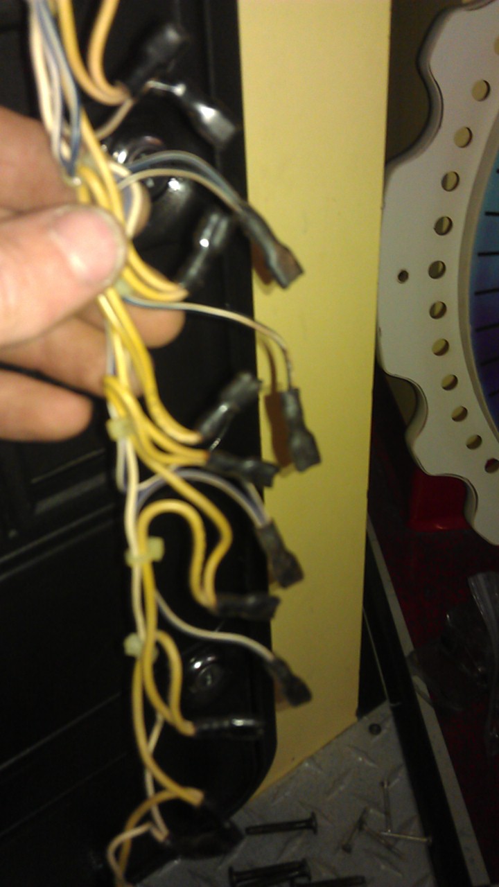 Wiring harness with yellow and white wires connected to black terminals