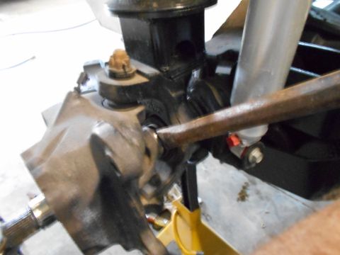 1992 Ford Bronco - Vehicle suspension part detail, possibly from a Ford Bronco, with a jack stand providing support.