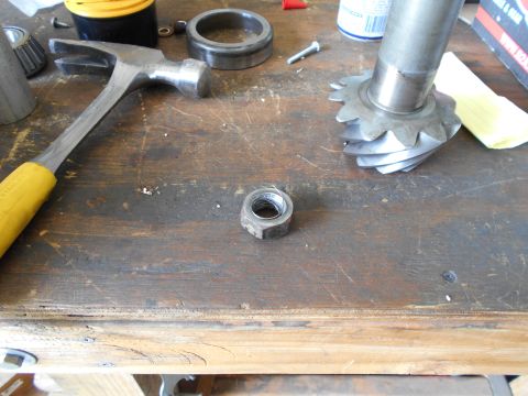1992 Ford Bronco - Tools and automotive parts are laid out on a wooden workbench.