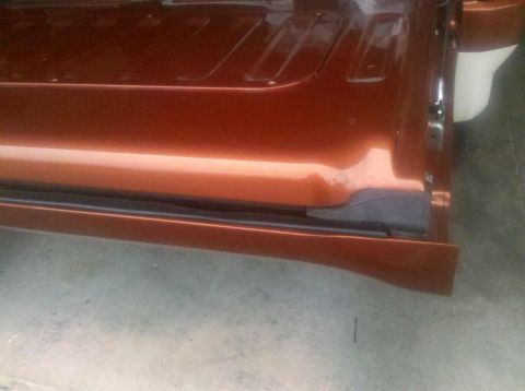 1982 Ford Bronco - Close-up of a car's door sill and lower door panel, showing the bodywork and trim.