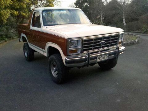 1982 Ford Bronco - This Ford Bronco features a two-tone paint scheme with wood grain accents on the lower body panels.