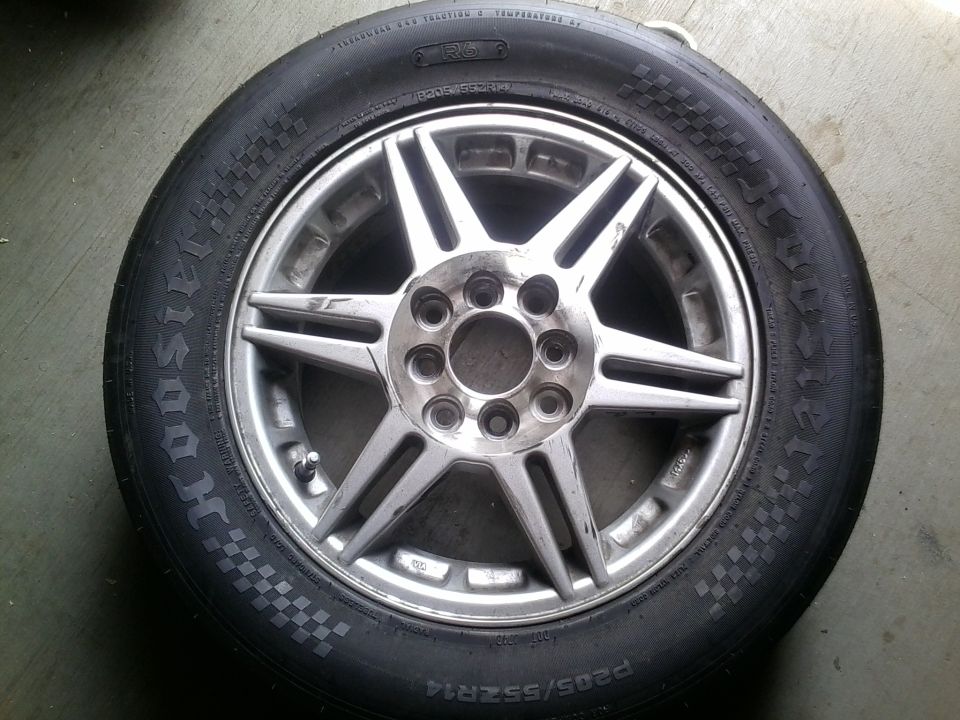 Aluminum alloy wheel with five split spokes and a tire with "SUPERMOTORS.NET" text