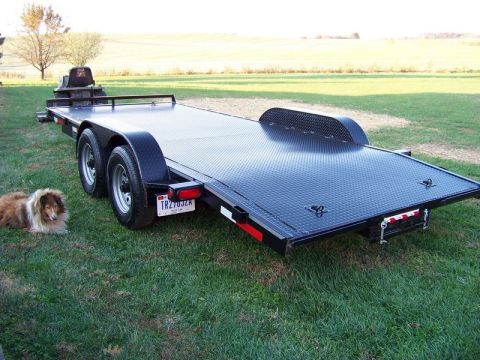 2005 Ford F-150 - Car hauler trailer with a dog resting on the grass next to it.