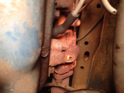 1973 Ford Bronco - Close-up view of an engine's exhaust manifold and surrounding components.