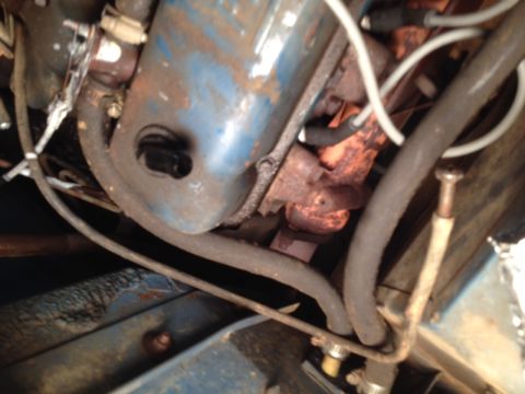 1973 Ford Bronco - Engine parts visible, including a blue valve cover and exhaust manifold. Supermotors.net logo in corner.