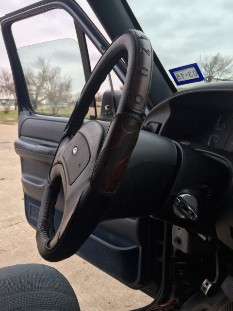 1993 Ford Bronco - Interior view of a vehicle's steering wheel and door panel.