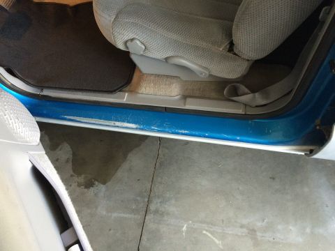 1995 Chevrolet Blazer - Interior view of a vehicle's door sill and seat, showing wear and tear.