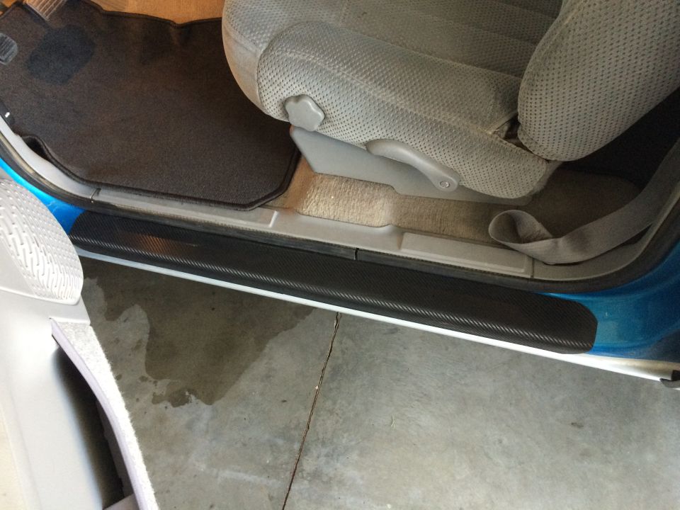 Interior door sill with carbon fiber trim and fabric seat