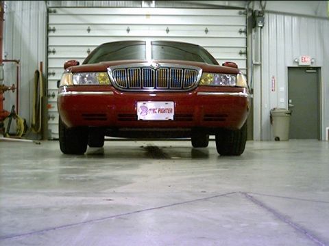 2000 Mercury Grand Marquis - Front view of a red 2000 Mercury Grand Marquis parked inside a garage.