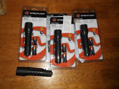 1995 Mercury Grand Marquis - Three new Streamlight Polytac flashlights and one loose flashlight are displayed on a wooden surface.
