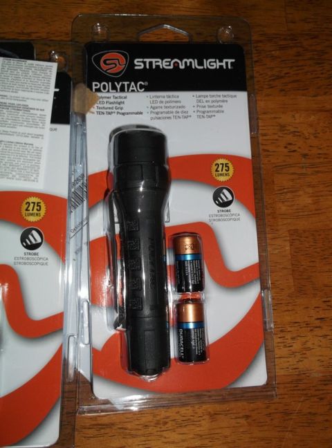 1995 Mercury Grand Marquis - This package contains a Streamlight Polytac tactical flashlight and two AA batteries.