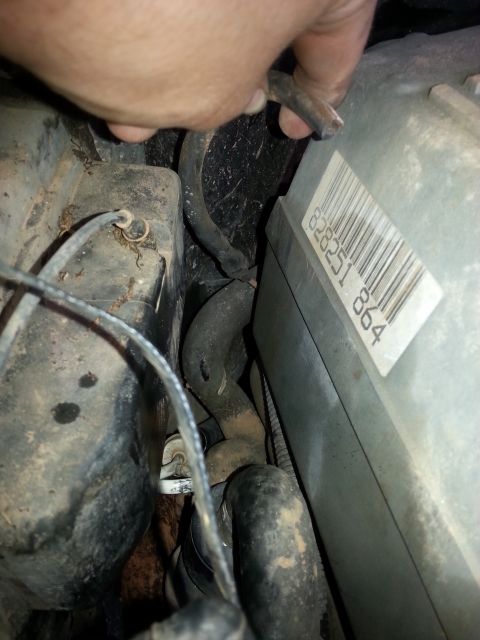 1994 Ford Bronco - A hand is shown manipulating a hose near some engine components and a labeled electronic control unit.