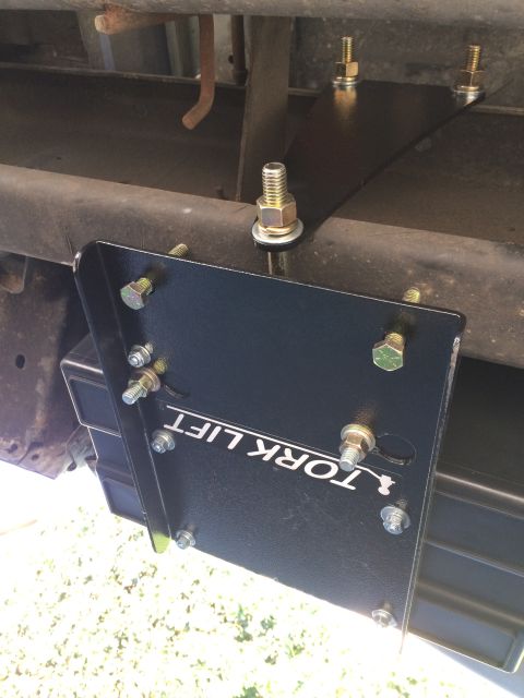 1997 Dodge 3500 - Torklift camper tie-down bracket mounted to the frame of a truck.