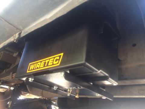 1997 Dodge 3500 - A black Wiretec storage box is mounted beneath the vehicle's frame, showing its bolted attachment.