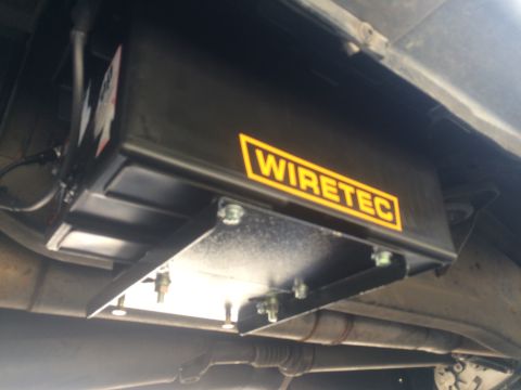 1997 Dodge 3500 - A close-up view of an aftermarket underbody component, identified by the "WIRETEC" logo.
