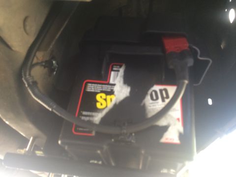 1997 Dodge 3500 - A vehicle battery with visible branding is shown, mounted beneath the chassis.