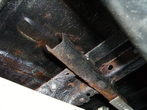 1978 Ford Bronco - Close-up view of the underbody frame and suspension components, showing signs of rust and wear.