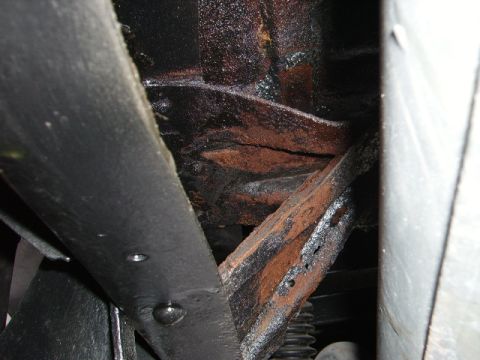 1978 Ford Bronco - Close-up view of heavily rusted frame components, likely from the undercarriage of a vehicle.