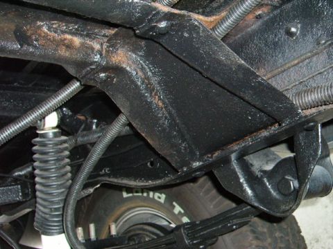 1978 Ford Bronco - Close-up view of the undercarriage, focusing on the frame and suspension components.