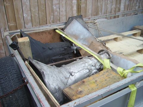 1978 Ford Bronco - Transmission parts are loaded onto a trailer for transport.