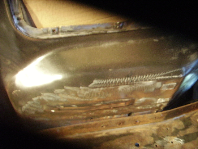 1978 Ford Bronco body panel with visible welding and grinding marks, showing rust and repair work