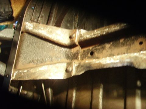 1978 Ford Bronco - This image shows a close-up view of rusty frame and suspension components, with visible text from Supermotors.net.