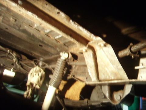 1978 Ford Bronco - The undercarriage of a vehicle, with visible rust on the frame and suspension parts.