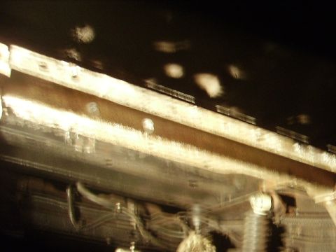 1978 Ford Bronco - The underside of a vehicle shows signs of wear and tear, with rust evident on the frame.