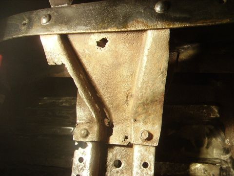 1978 Ford Bronco - Detail of heavily rusted automotive frame components, showing corrosion and structural wear.